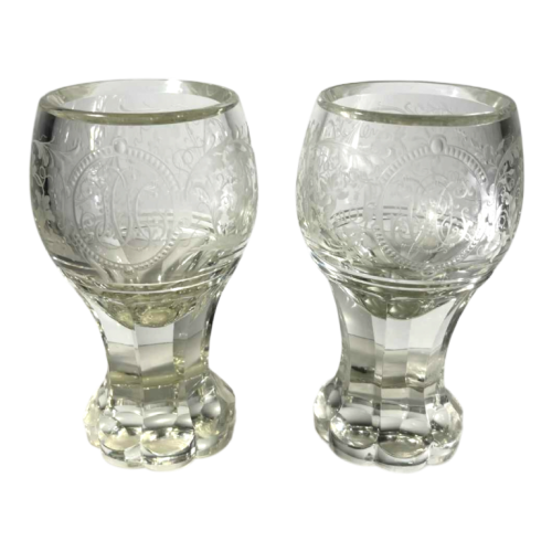 Pair of stemmed glasses in thick cut crystal with scrolling decoration and monogram, Bohemia ca 1900
